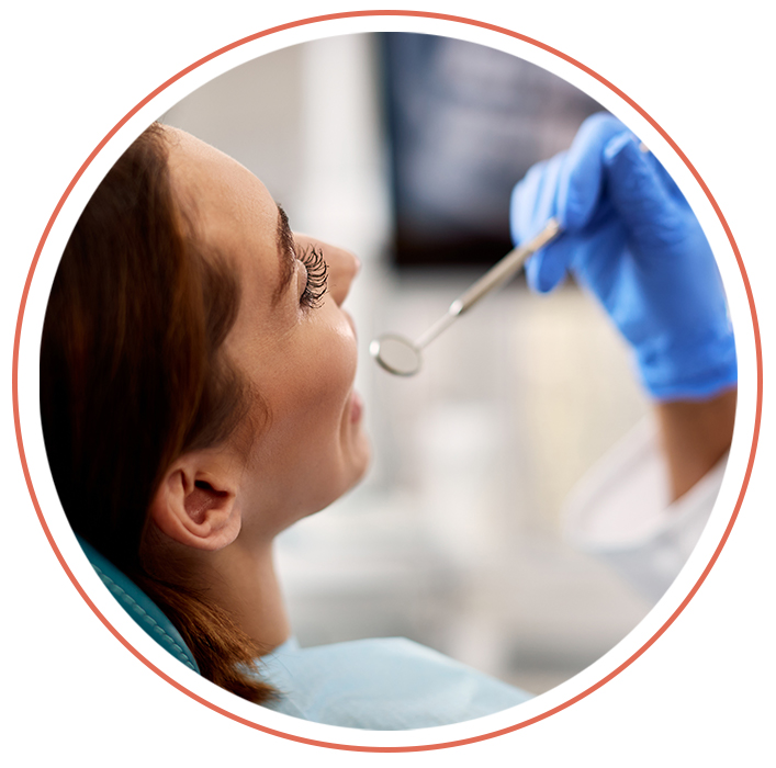 dentist checking woman's teeth