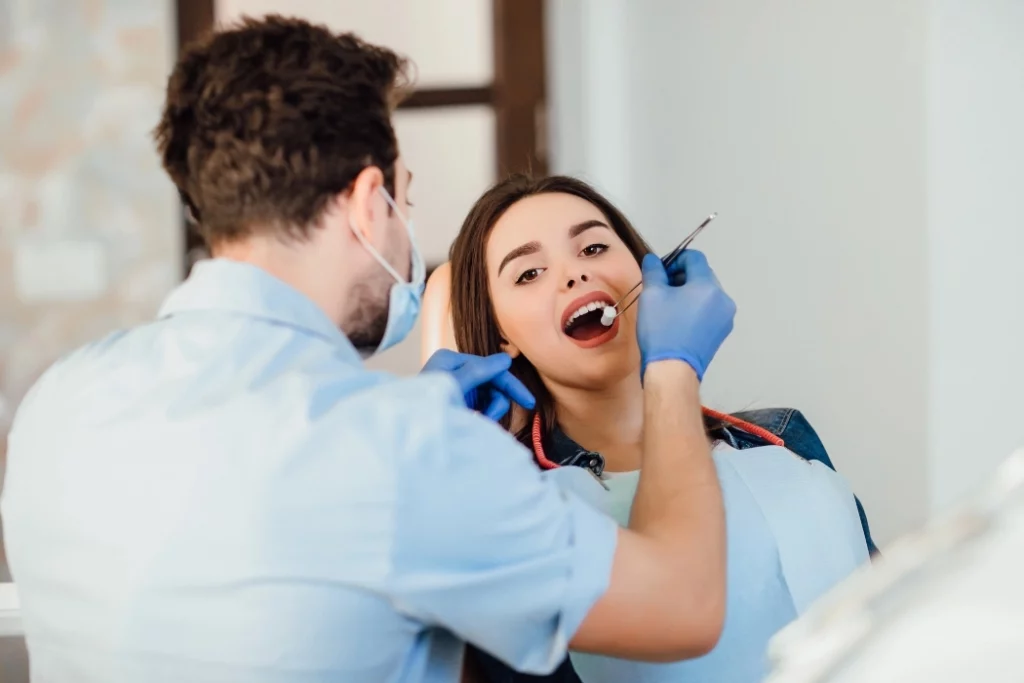 Dentist doing dental cleaning on patient